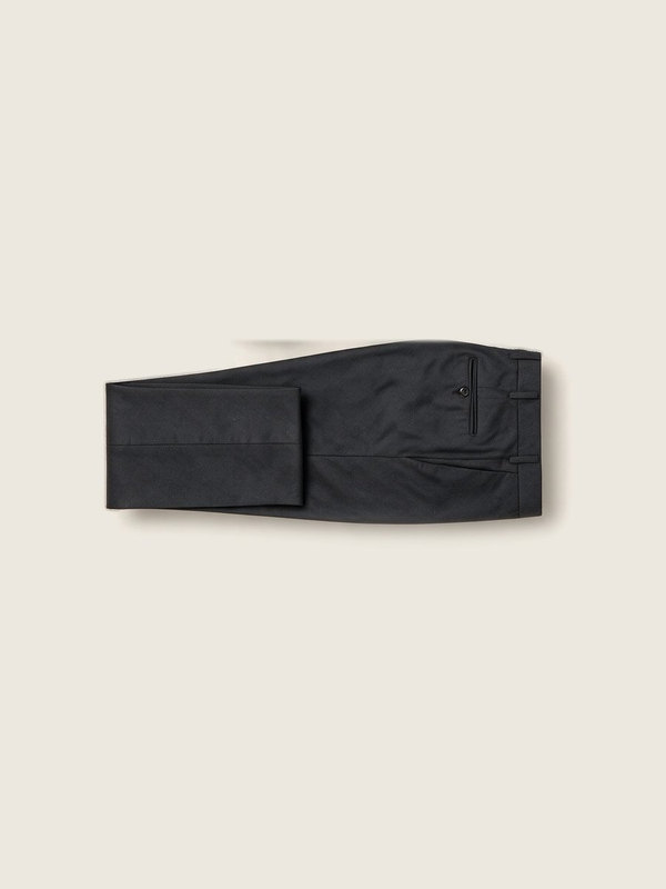 A pair of charcoal formal trousers, folded.